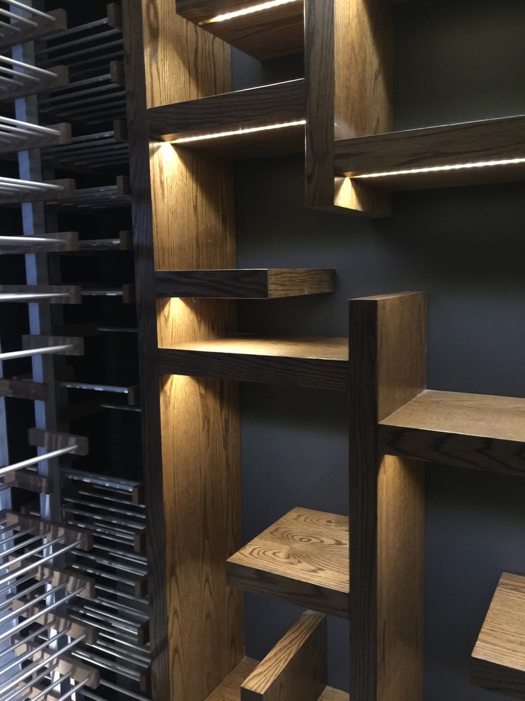 This is an example of a medium sized contemporary wine cellar in Toronto with ceramic flooring, storage racks and white floors.