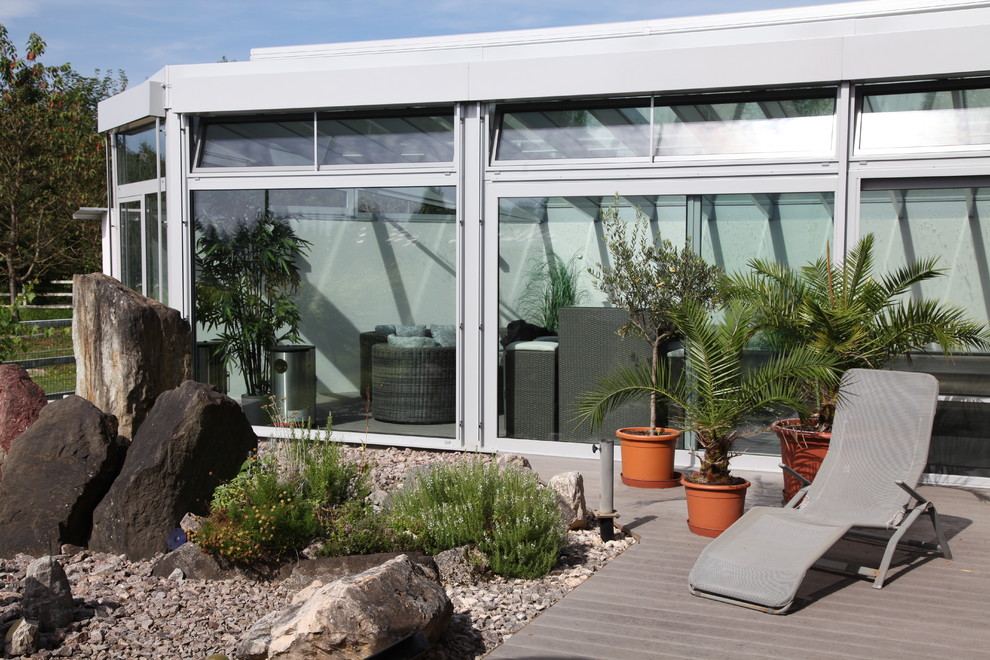 Example of a large trendy sunroom design in Stuttgart with a glass ceiling