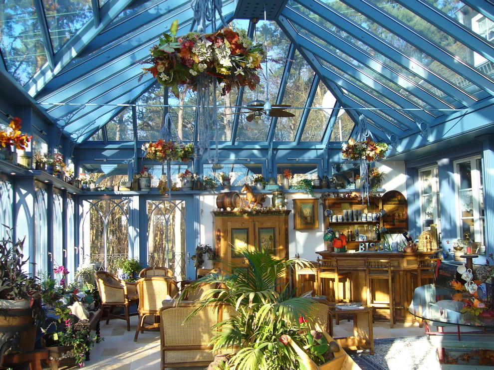 This is an example of an expansive victorian conservatory in Dortmund with porcelain flooring and a glass ceiling.