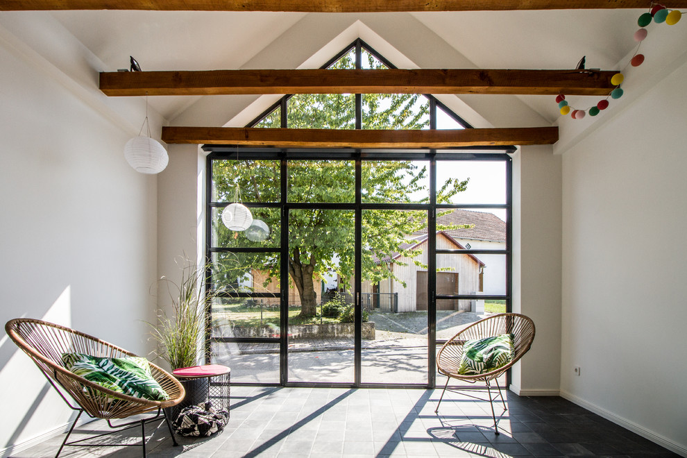 This is an example of a small scandi conservatory in Munich with no fireplace, grey floors and a standard ceiling.