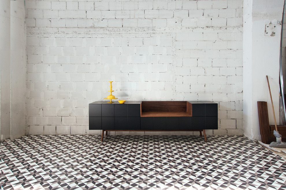 Example of a mid-sized trendy formal and loft-style ceramic tile and multicolored floor living room design in Berlin with gray walls, no fireplace, a concrete fireplace and no tv