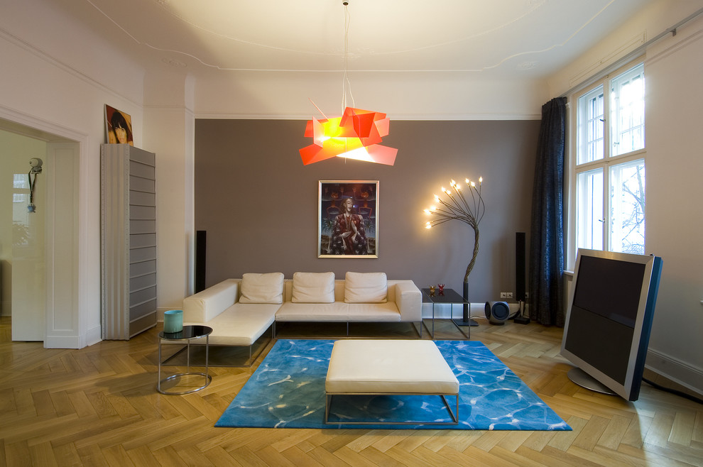 Источник вдохновения для домашнего уюта: открытая гостиная комната среднего размера в современном стиле с серыми стенами и светлым паркетным полом