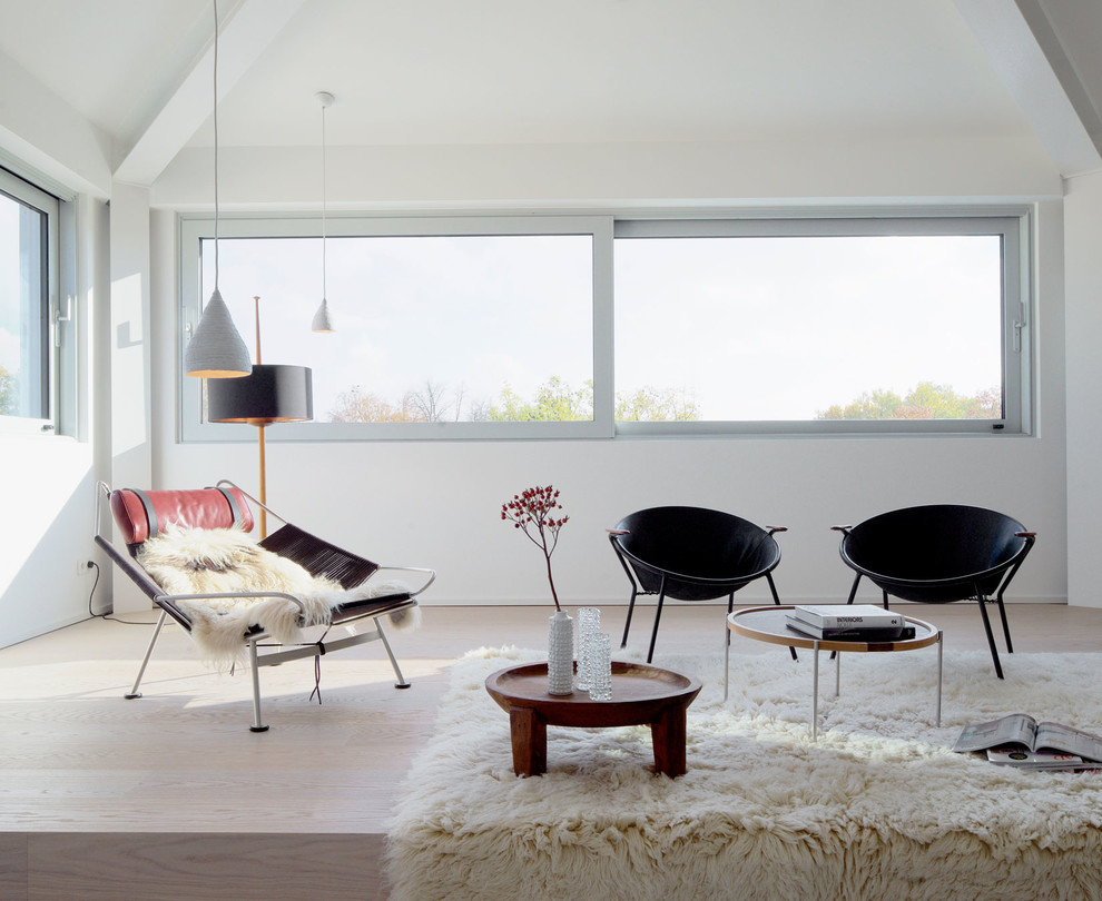Mittelgroßes, Fernseherloses Modernes Wohnzimmer im Loft-Stil, ohne Kamin mit weißer Wandfarbe, hellem Holzboden und beigem Boden in Leipzig