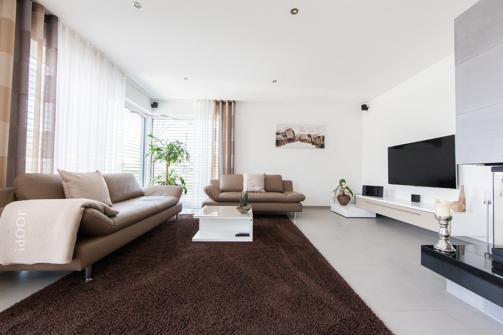 Medium sized contemporary enclosed games room in Other with white walls, a two-sided fireplace, a concrete fireplace surround, a wall mounted tv and grey floors.