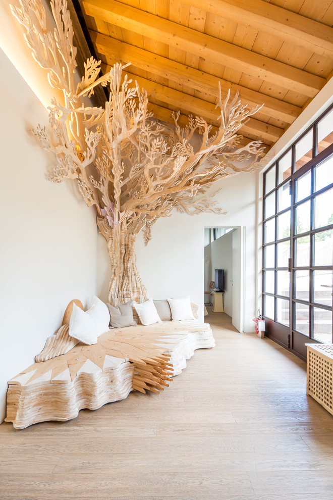 Esempio di un soggiorno eclettico aperto con pareti bianche, parquet chiaro e pavimento beige