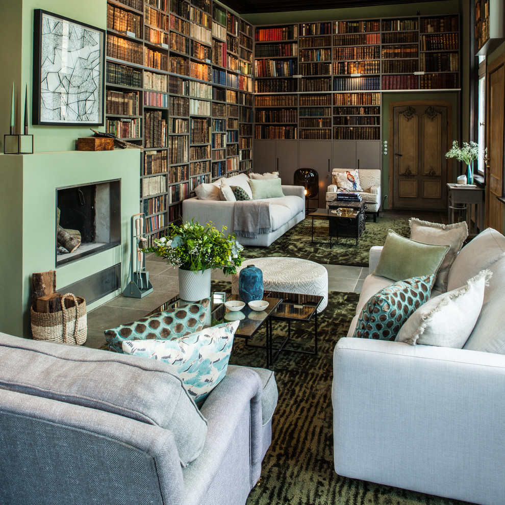 Family room library - huge contemporary enclosed concrete floor family room library idea in Hamburg with green walls, a standard fireplace, a plaster fireplace and no tv