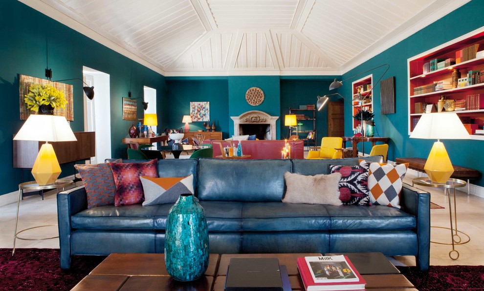 Example of a trendy marble floor family room library design in Stuttgart with blue walls, a standard fireplace and a stone fireplace