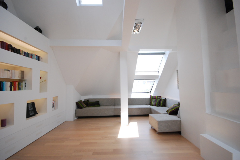 Photo of a large modern open plan living room in Munich with white walls.