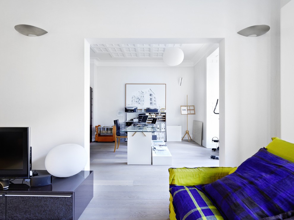 This is an example of a large contemporary formal open plan living room in Stuttgart with dark hardwood flooring and a freestanding tv.