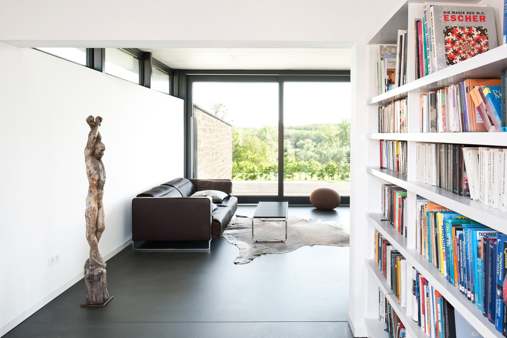 Design ideas for a contemporary open plan living room in Nuremberg with white walls and concrete flooring.