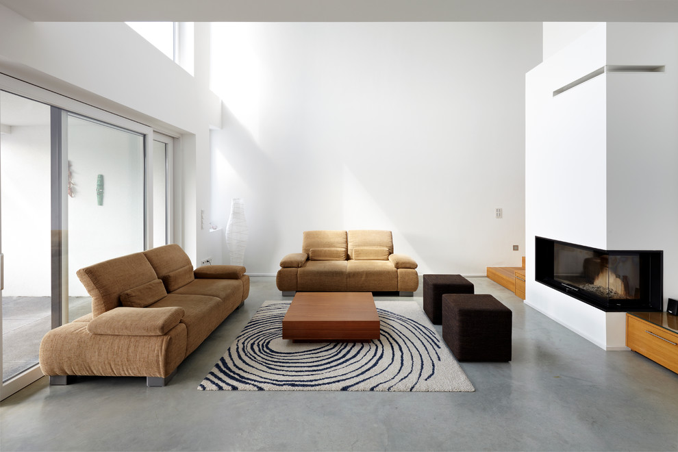 This is an example of a large contemporary formal open plan living room in Cologne with white walls, concrete flooring, a plastered fireplace surround, no tv and a ribbon fireplace.