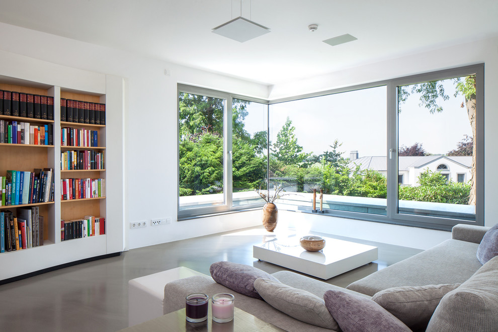 This is an example of a large contemporary enclosed living room in Essen with white walls, no fireplace and no tv.