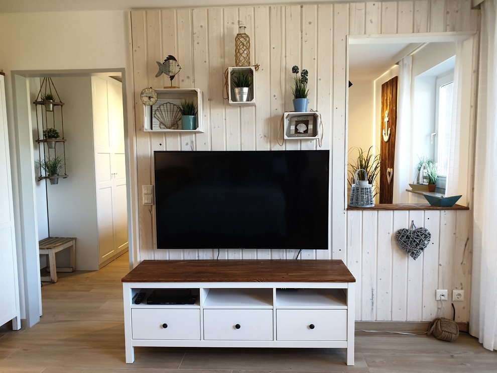 Photo of a small scandinavian open plan games room in Other with white walls, ceramic flooring, a wall mounted tv and brown floors.