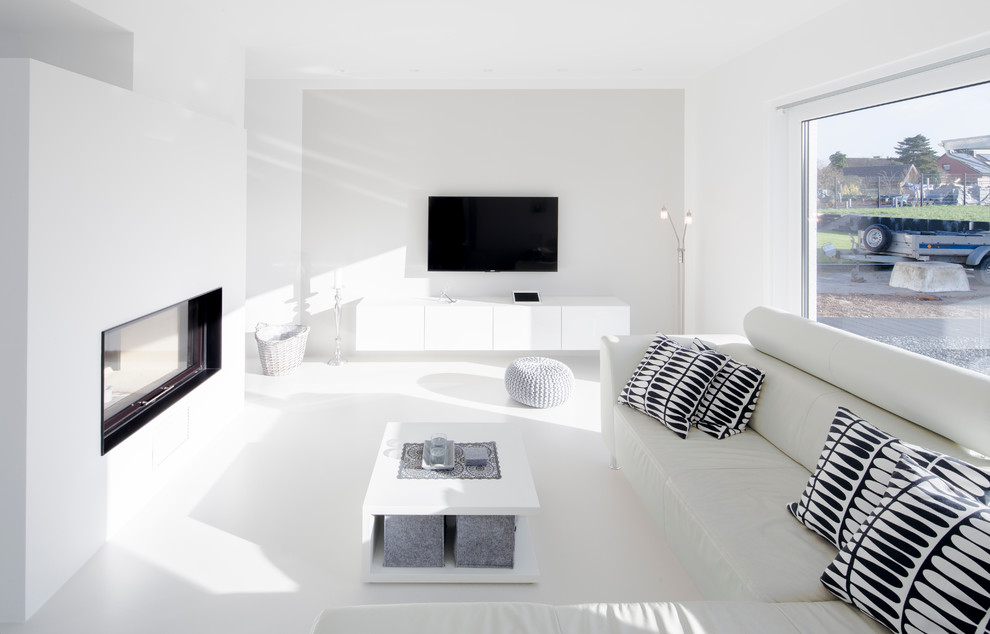 Esempio di un soggiorno contemporaneo di medie dimensioni con pareti bianche, camino bifacciale, cornice del camino in intonaco e TV a parete