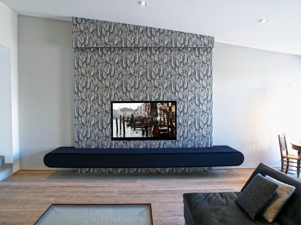 Inspiration for a contemporary open concept living room remodel in Cologne with white walls and a wall-mounted tv