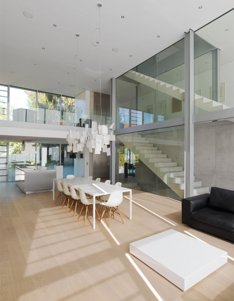 Esempio di un grande soggiorno moderno aperto con parquet chiaro