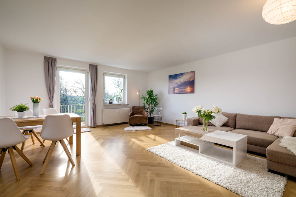 Großes, Repräsentatives, Fernseherloses, Abgetrenntes Skandinavisches Wohnzimmer ohne Kamin mit weißer Wandfarbe, braunem Holzboden und braunem Boden in München
