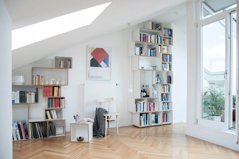 Diseño de sala de estar con biblioteca cerrada escandinava de tamaño medio sin chimenea y televisor con paredes blancas, suelo de madera en tonos medios y suelo marrón