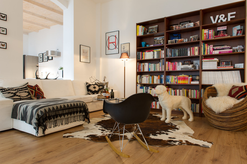 На фото: изолированная гостиная комната среднего размера в стиле фьюжн с с книжными шкафами и полками, белыми стенами, паркетным полом среднего тона и ковром на полу
