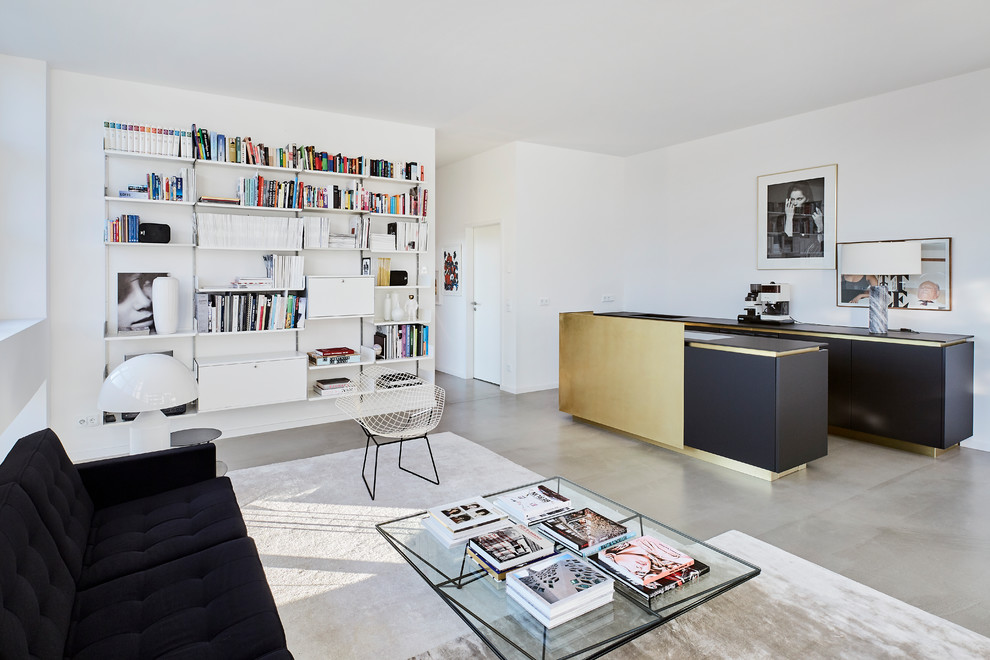 This is an example of a medium sized contemporary formal mezzanine living room in Cologne with white walls, concrete flooring, no fireplace and grey floors.