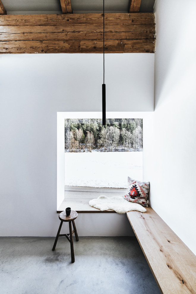 Ispirazione per un soggiorno stile rurale con pareti bianche, pavimento in cemento e pavimento grigio