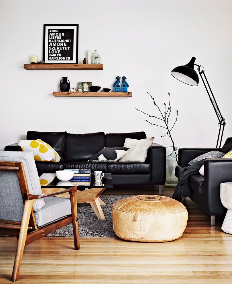 Example of a danish medium tone wood floor and beige floor family room design in Other with white walls