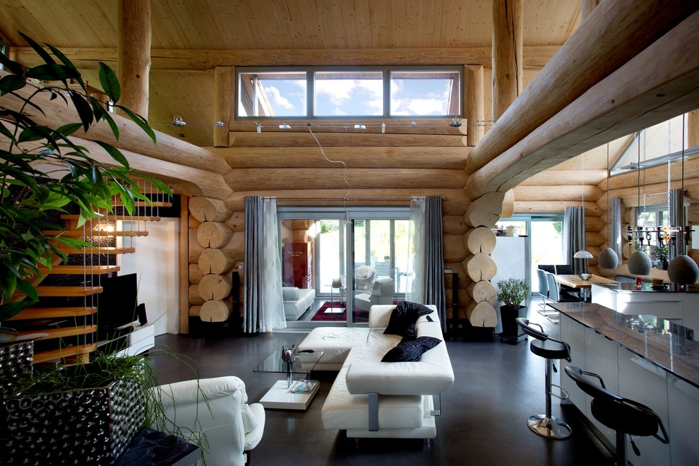 This is an example of an expansive rustic formal mezzanine living room in Other with brown walls, lino flooring, a freestanding tv and black floors.