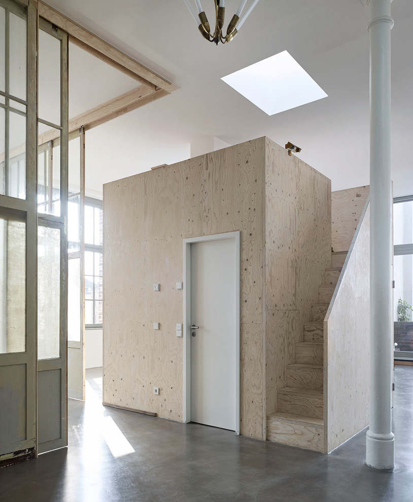 Inspiration for an expansive urban formal mezzanine living room in Leipzig with white walls and concrete flooring.