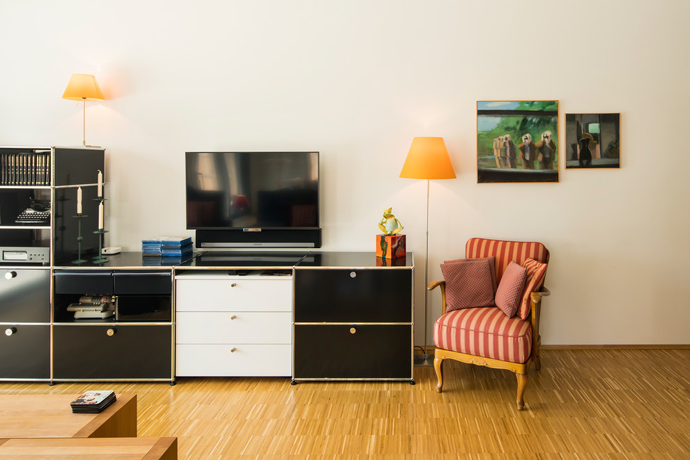 Contemporary living room in Other with white walls, light hardwood flooring, no fireplace and brown floors.