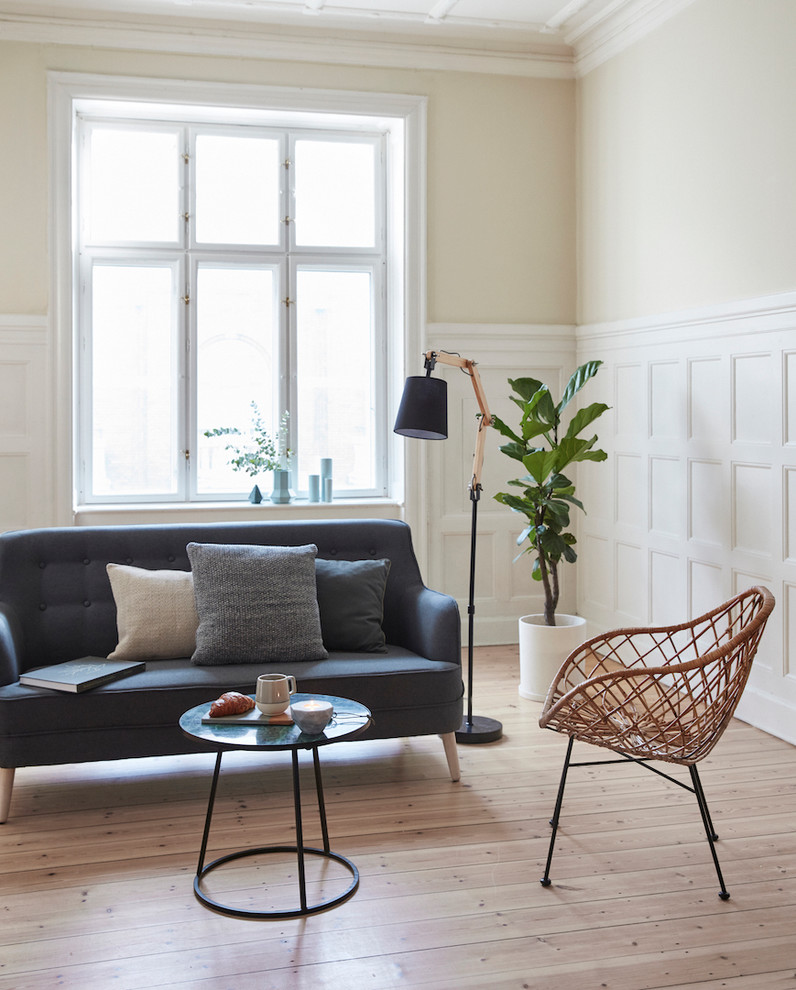 Ejemplo de sala de estar nórdica sin chimenea con paredes beige y suelo de madera clara