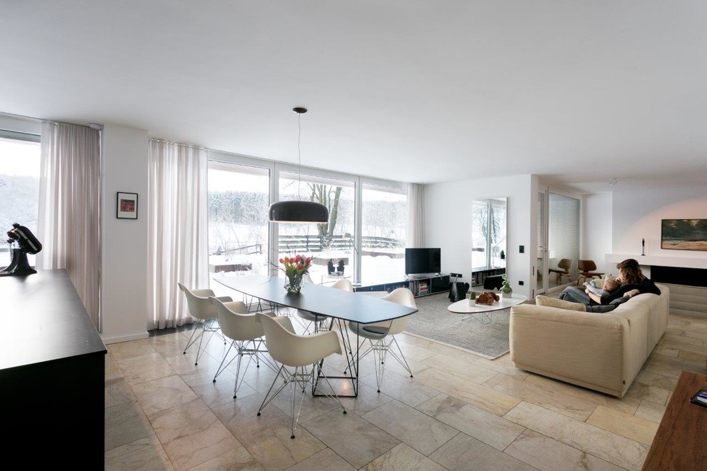 This is an example of a modern open plan dining room in Cologne with white walls, marble flooring, no fireplace, beige floors, a wallpapered ceiling and wallpapered walls.