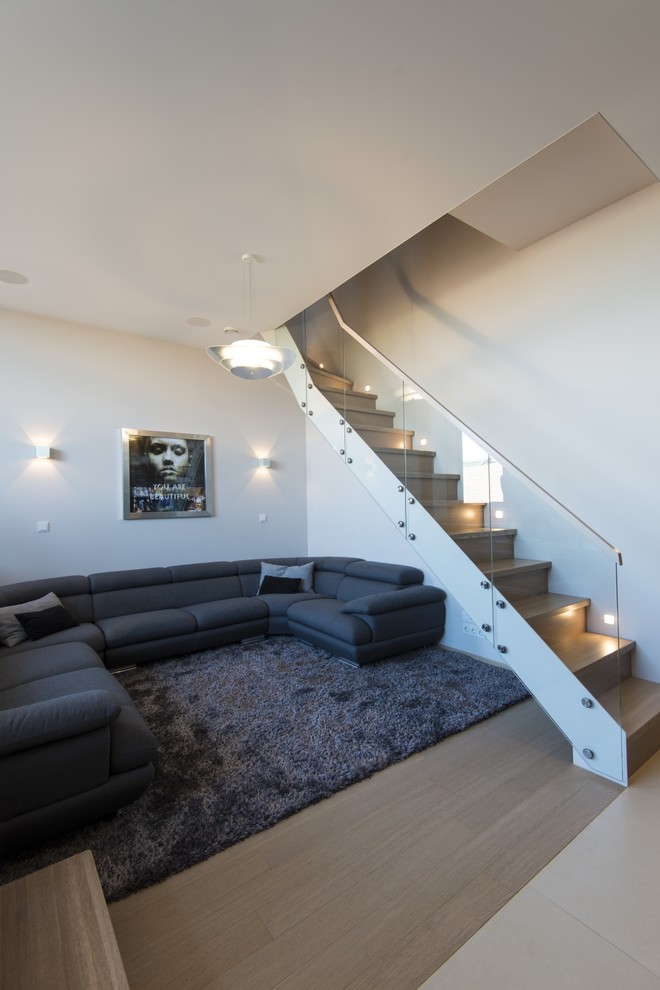 Großes, Offenes Modernes Wohnzimmer ohne Kamin mit weißer Wandfarbe und braunem Holzboden in Berlin