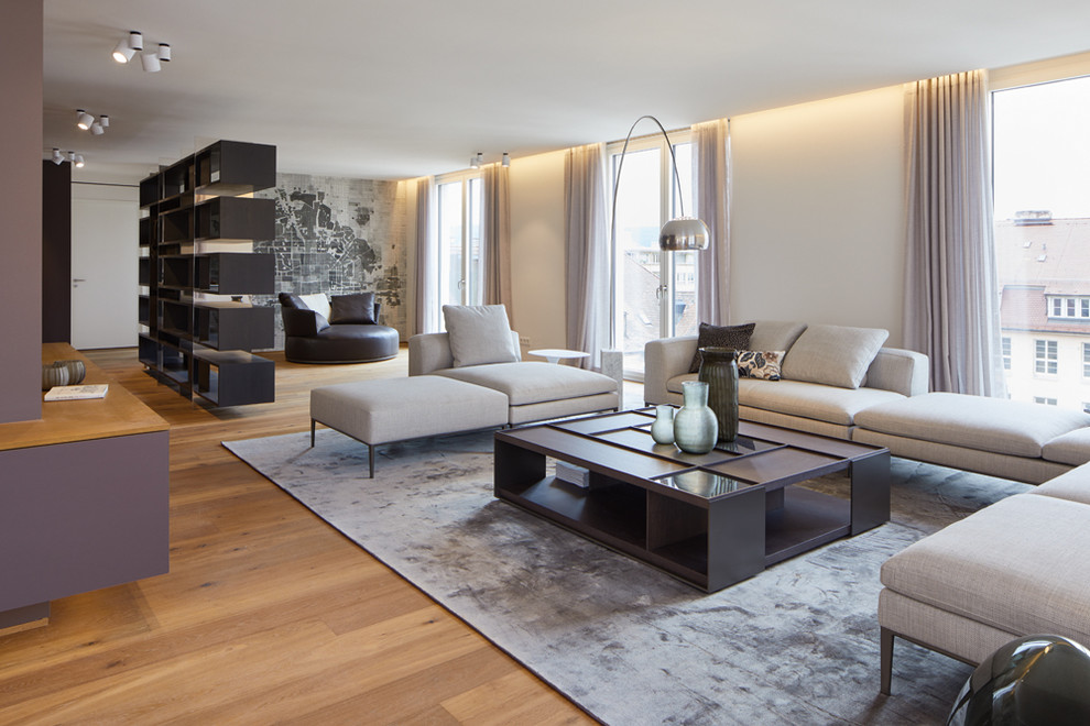 Inspiration for an expansive contemporary formal mezzanine living room in Stuttgart with grey walls, medium hardwood flooring and brown floors.