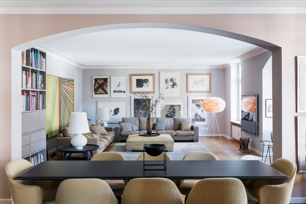 Medium sized classic enclosed living room in Munich with grey walls, light hardwood flooring, no fireplace and a wall mounted tv.