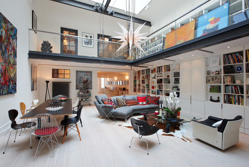 Inspiration for a large contemporary open plan games room in Hamburg with a reading nook, white walls, light hardwood flooring and no fireplace.