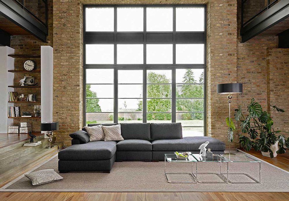 Large trendy formal and open concept medium tone wood floor living room photo in Bremen with brown walls