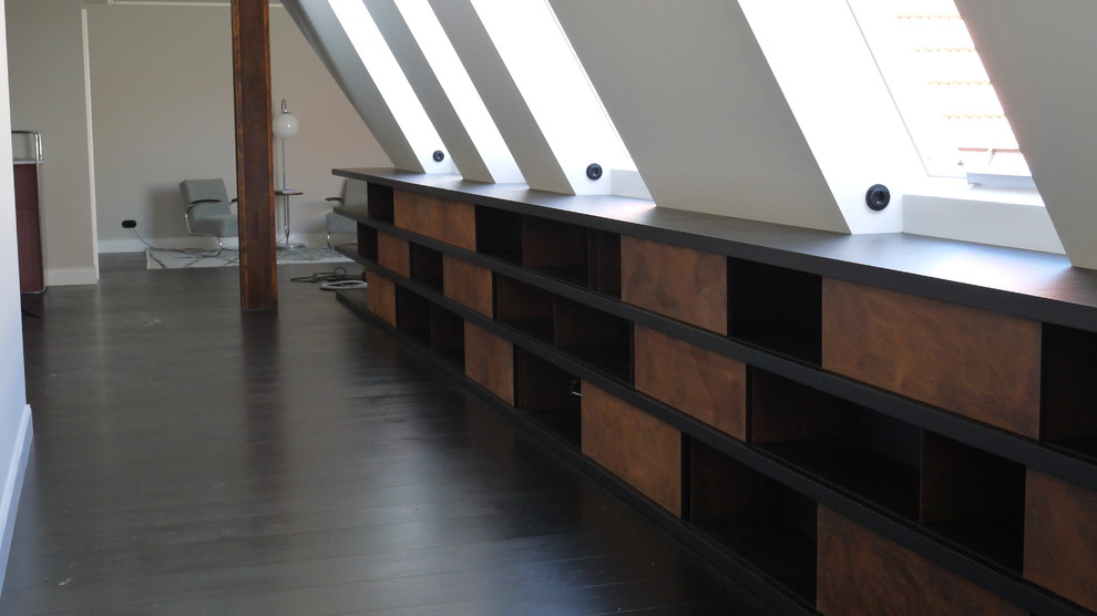 Example of a trendy loft-style medium tone wood floor living room design in Berlin