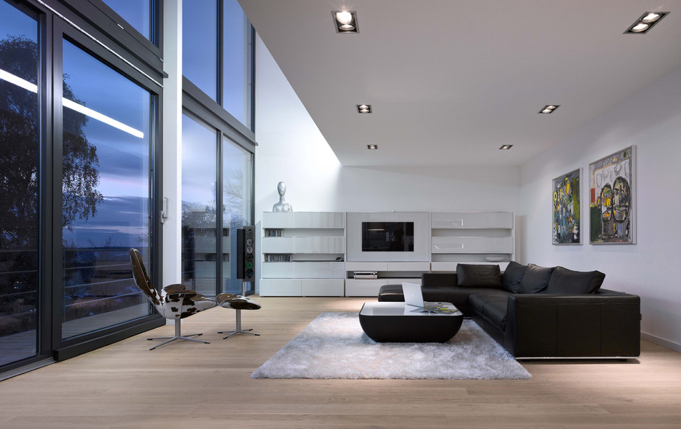 Inspiration for a large contemporary formal and open concept medium tone wood floor living room remodel in Stuttgart with white walls, a media wall and no fireplace