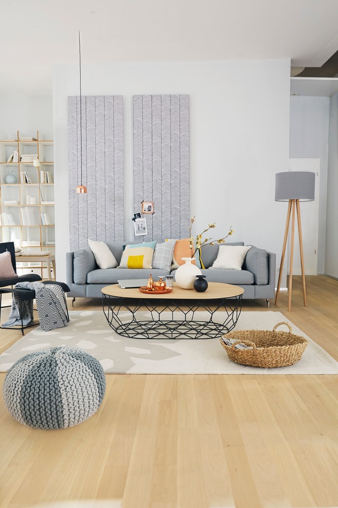 Living room - mid-sized scandinavian light wood floor living room idea in Other with white walls