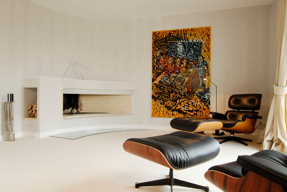 This is an example of a large contemporary enclosed living room in Hamburg with beige walls, carpet and a stone fireplace surround.
