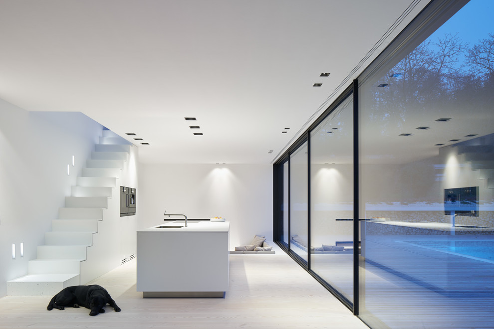 Пример оригинального дизайна: огромная открытая гостиная комната в стиле модернизм с белыми стенами и светлым паркетным полом