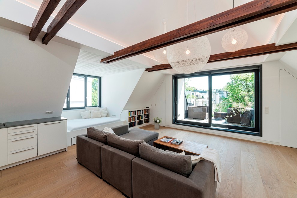 Example of a trendy loft-style light wood floor living room design in Hamburg with white walls