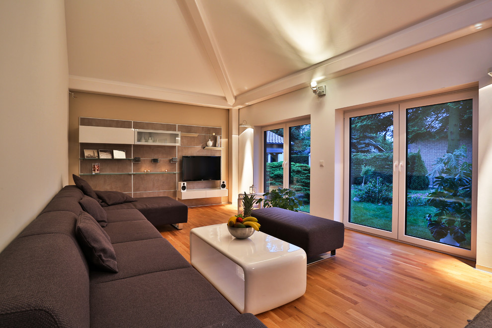 Inspiration for a large contemporary formal open plan living room in Berlin with white walls and a wall mounted tv.