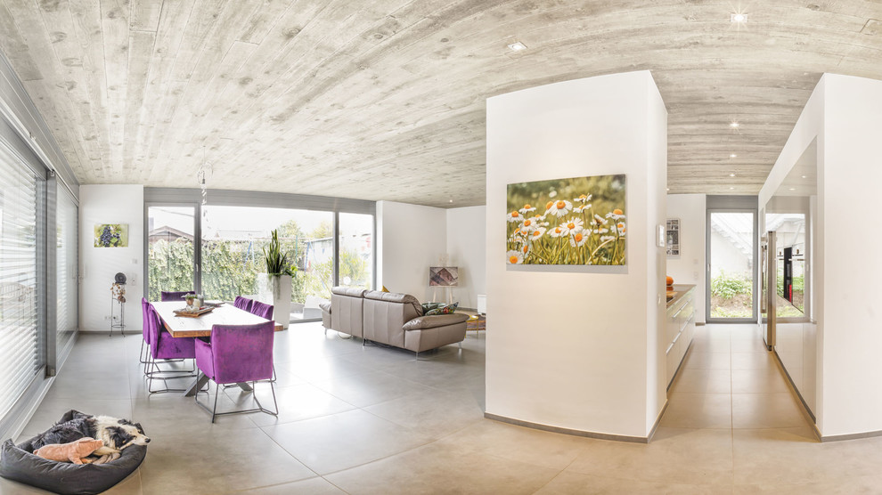 Modelo de salón para visitas abierto contemporáneo extra grande sin chimenea con paredes blancas, suelo de baldosas de porcelana, televisor colgado en la pared y suelo gris