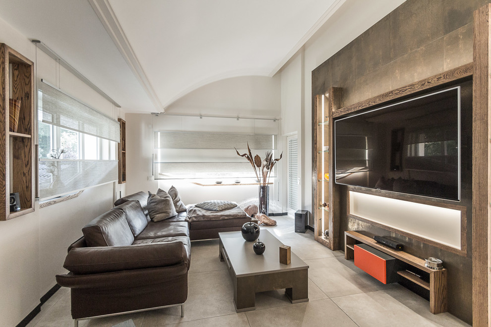 This is an example of a medium sized contemporary mezzanine games room in Dortmund with beige walls, ceramic flooring, a corner fireplace, a wooden fireplace surround, a built-in media unit and beige floors.