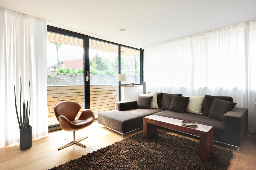 Inspiration for a modern formal light wood floor living room remodel in Hamburg with no fireplace and no tv