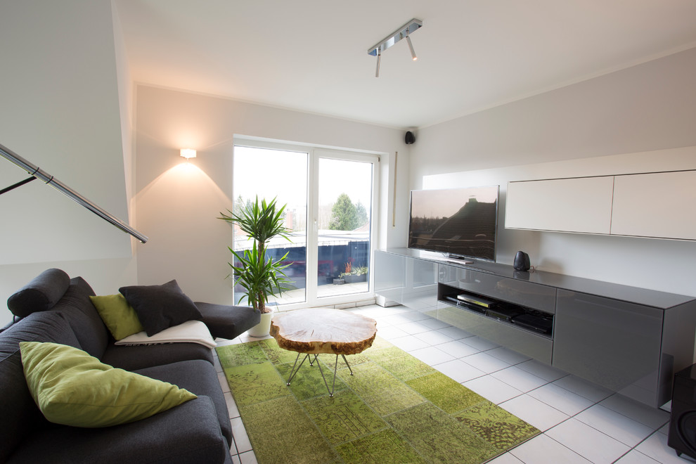 Exemple d'une salle de séjour tendance ouverte avec un mur blanc et un téléviseur encastré.