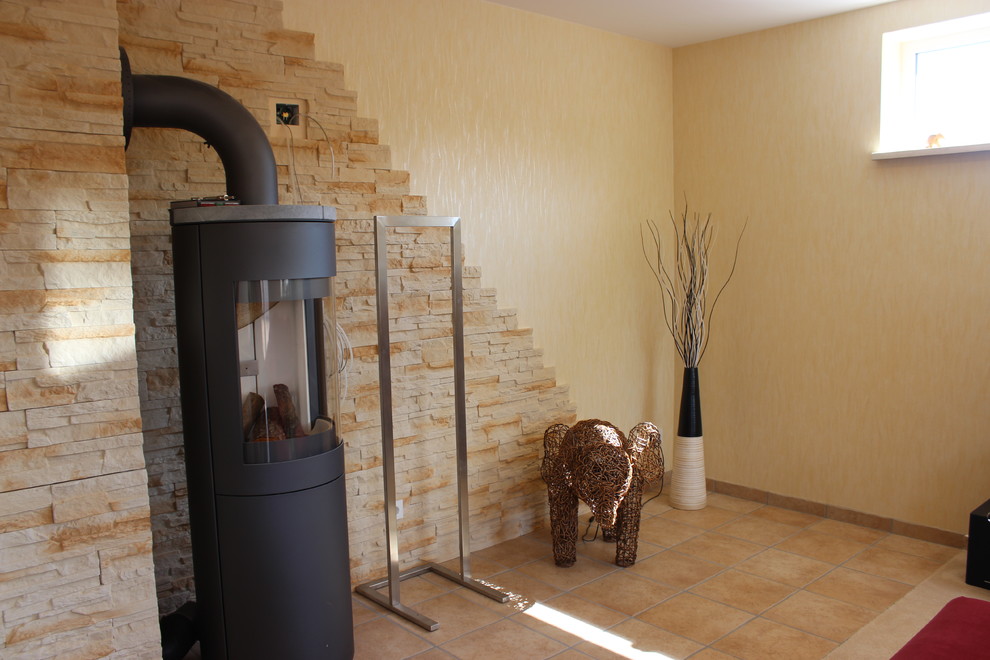 Diseño de sala de estar abierta contemporánea de tamaño medio con paredes amarillas, suelo de piedra caliza y suelo beige