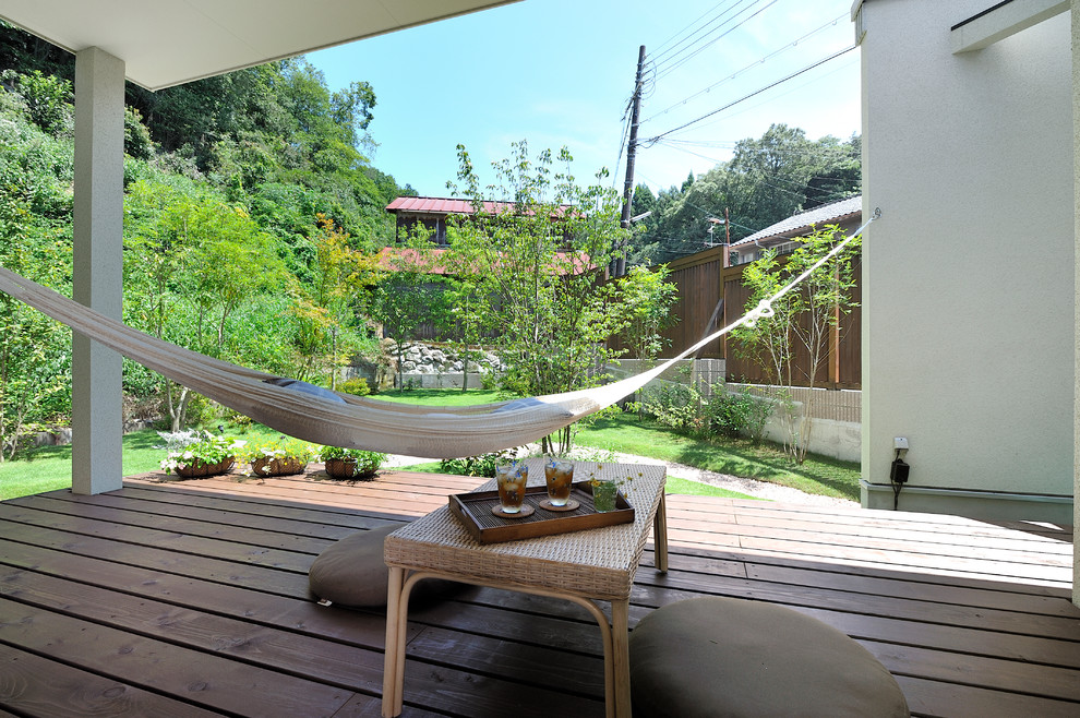 Idéer för en asiatisk terrass längs med huset, med takförlängning