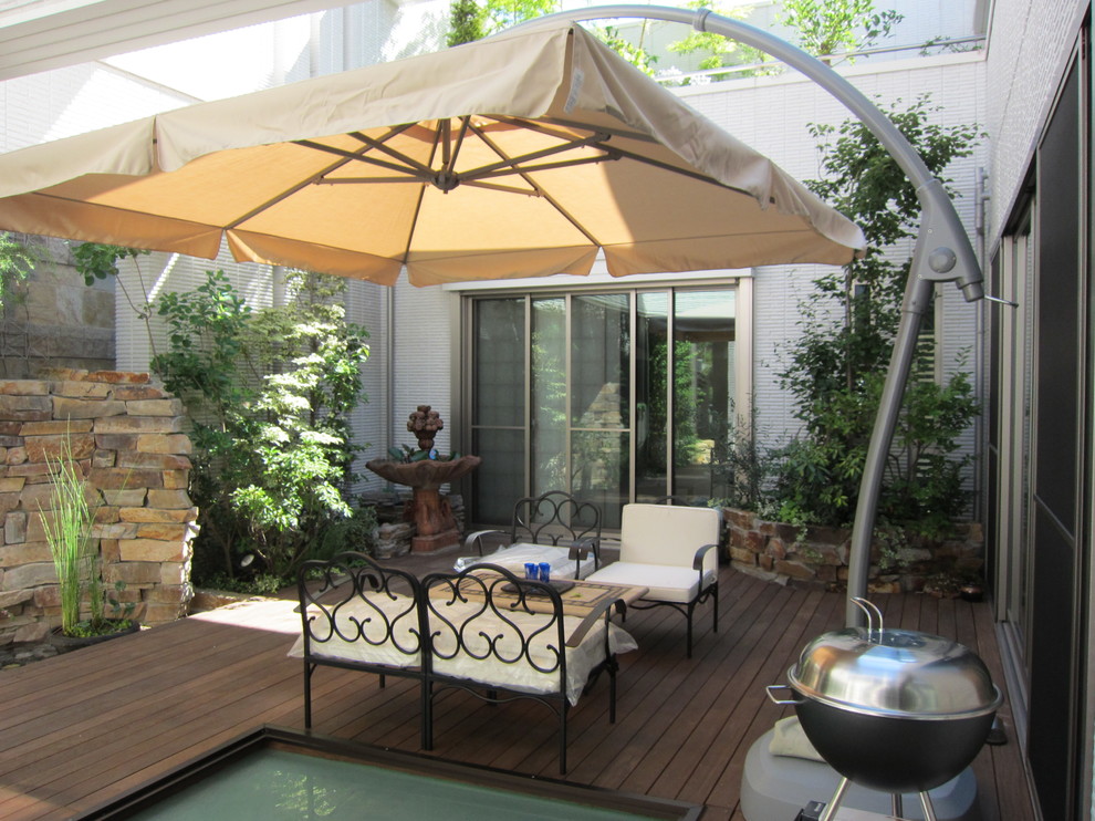 Example of a trendy rooftop deck design in Tokyo with a pergola